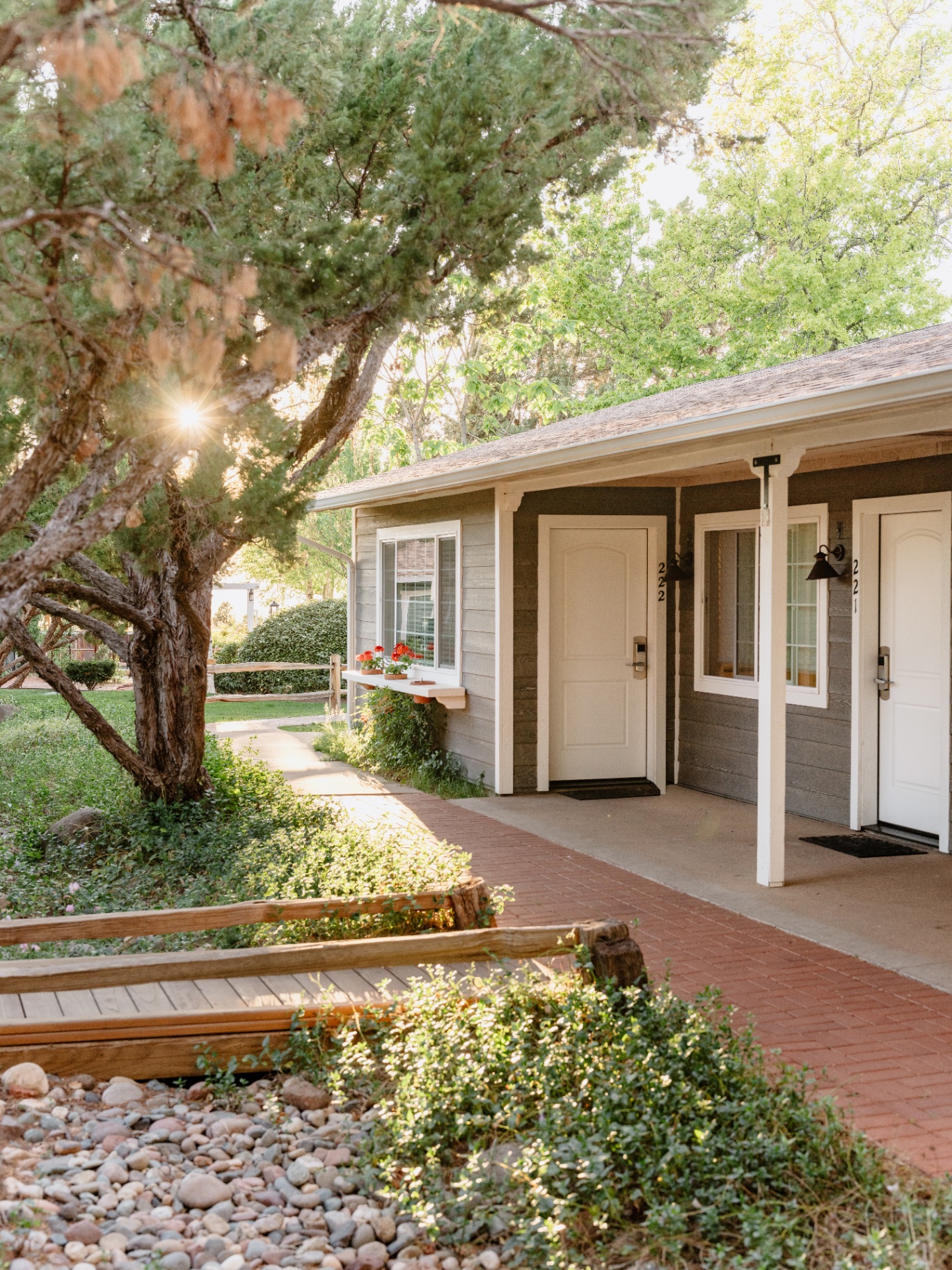 Sky Ranch Lodge cottage exterior with shaded porch and garden path