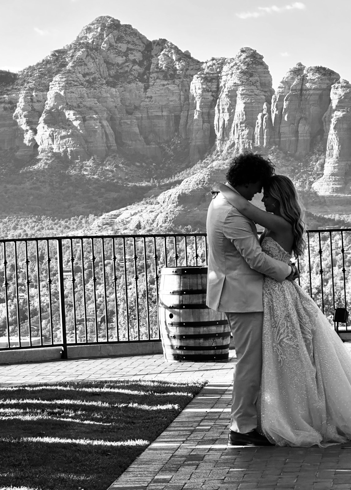 Bride and groom embrace on a Sky Ranch Lodge terrace with Sedona red rock views