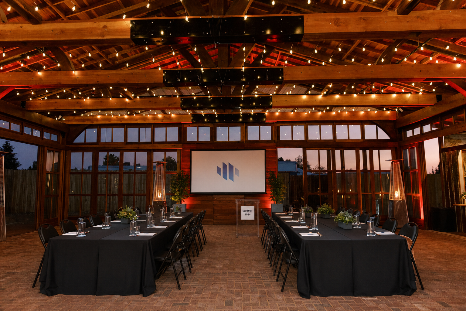 The Pavilion set for a corporate event with string lights and presentation screen