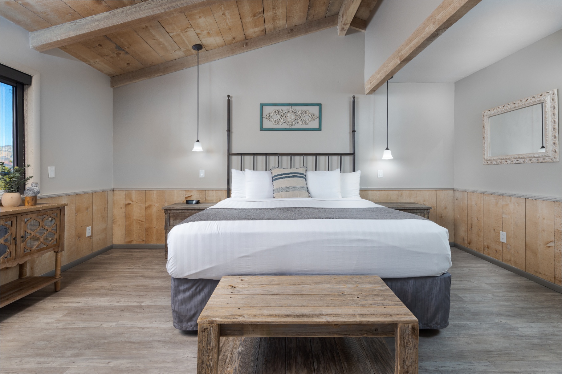 Cottage king bed with vaulted wood-beamed ceiling