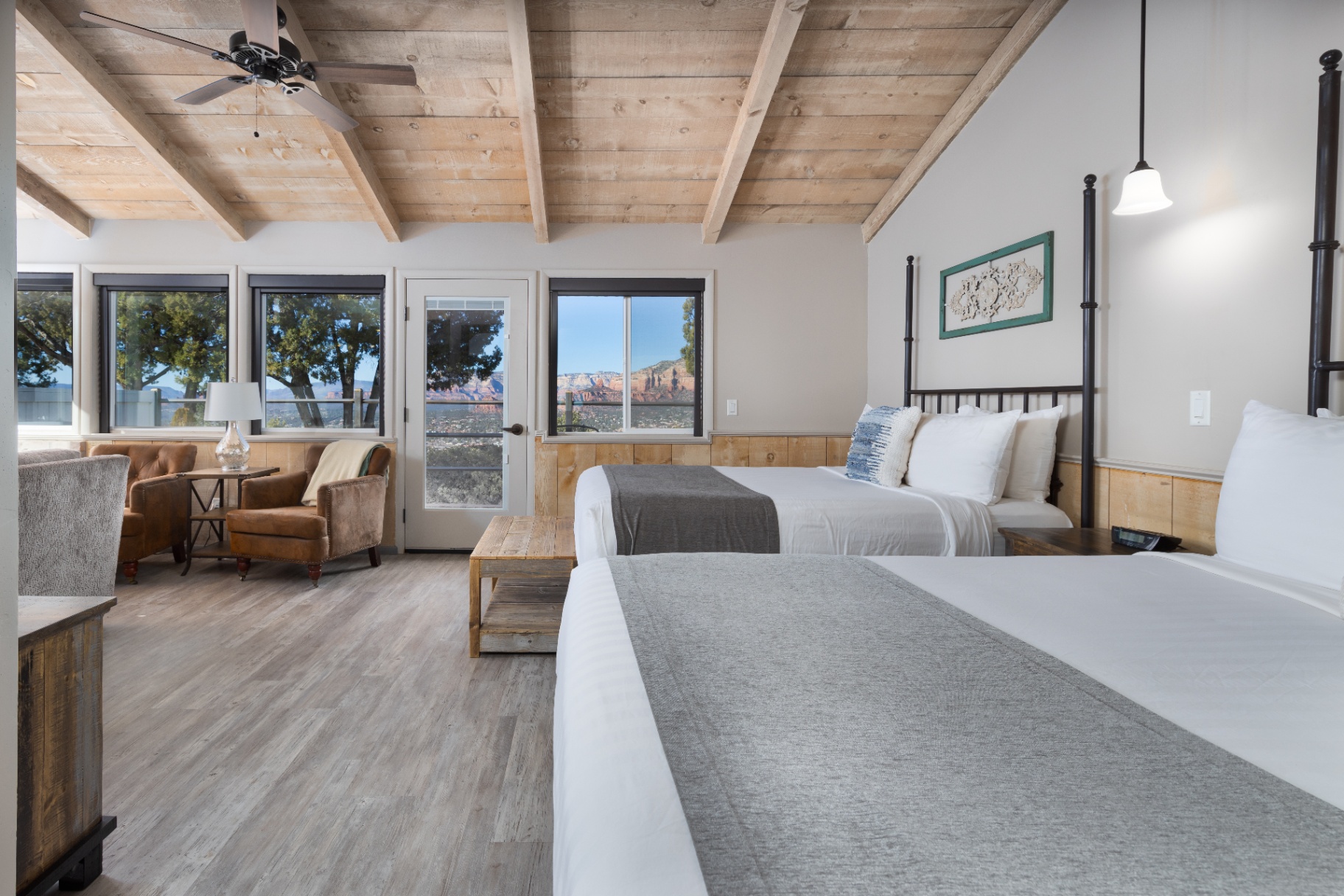 Two queen beds facing the sitting area and patio door