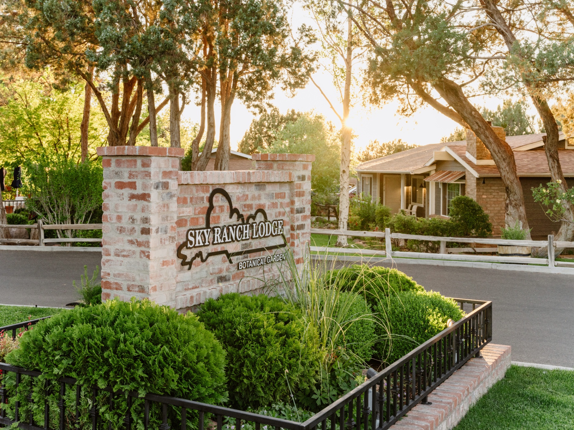 Sky Ranch Lodge botanical garden sign at golden hour