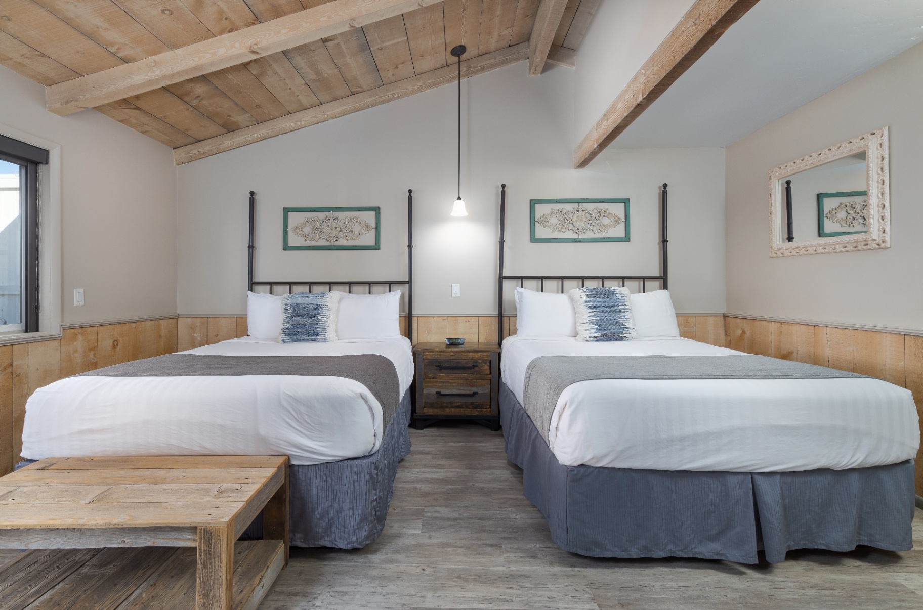 Queen cottage bedroom with two beds and wood-beamed ceiling